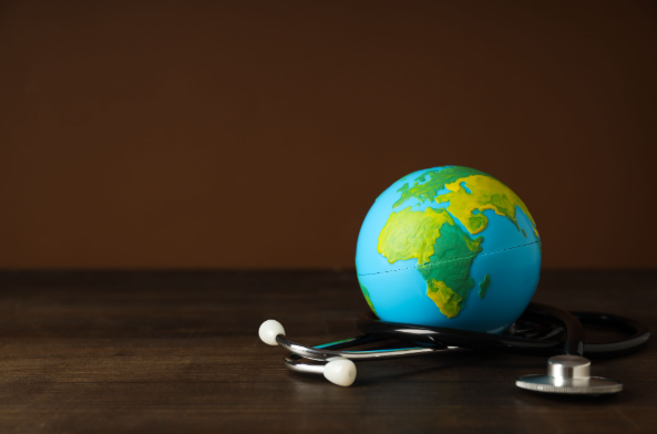 Globe on stethoscope representing international health insurance, global medical coverage, and access to care in different countries.